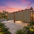 Outdoor pergola with motorized shade screens on a stone patio
