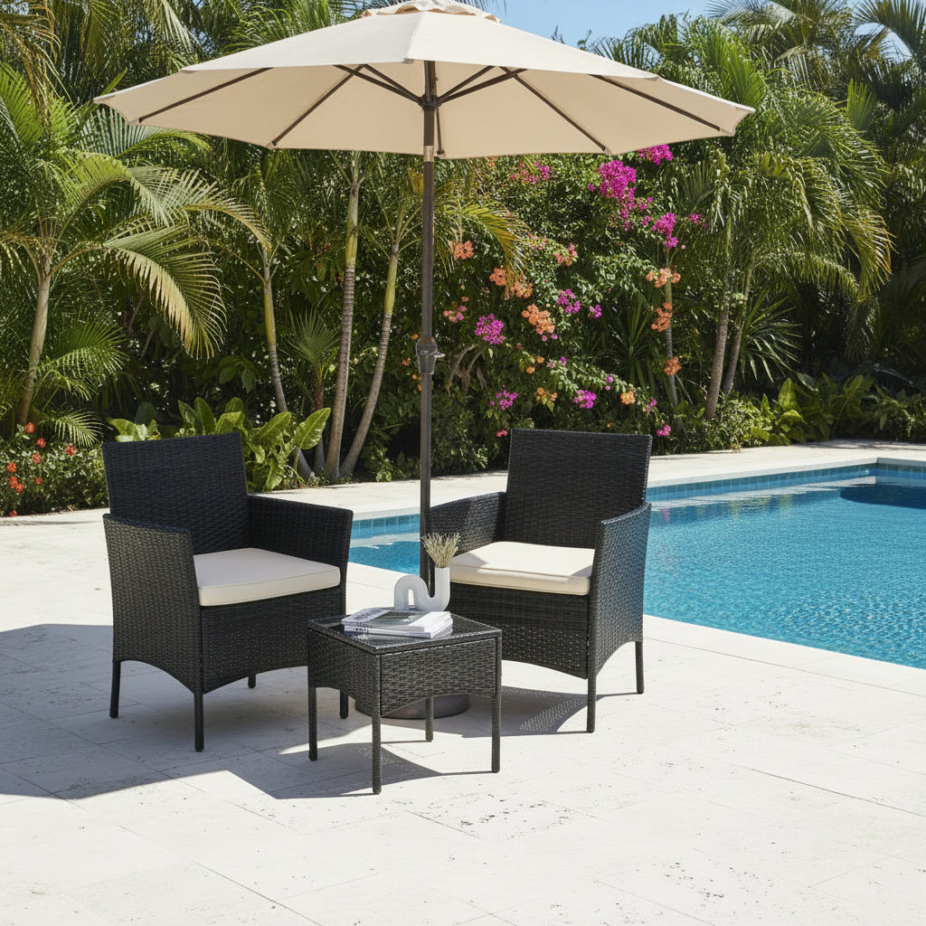 Black wicker outdoor furniture set with white cushions on a pool with umbrella background