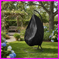 Black swing chair cover on a garden background